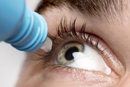 man-using-eye-drops-close-up man-using-eye-drops-close-up